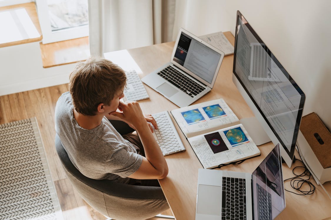 Developer working with multiple screens and code, representing a professional web application
development